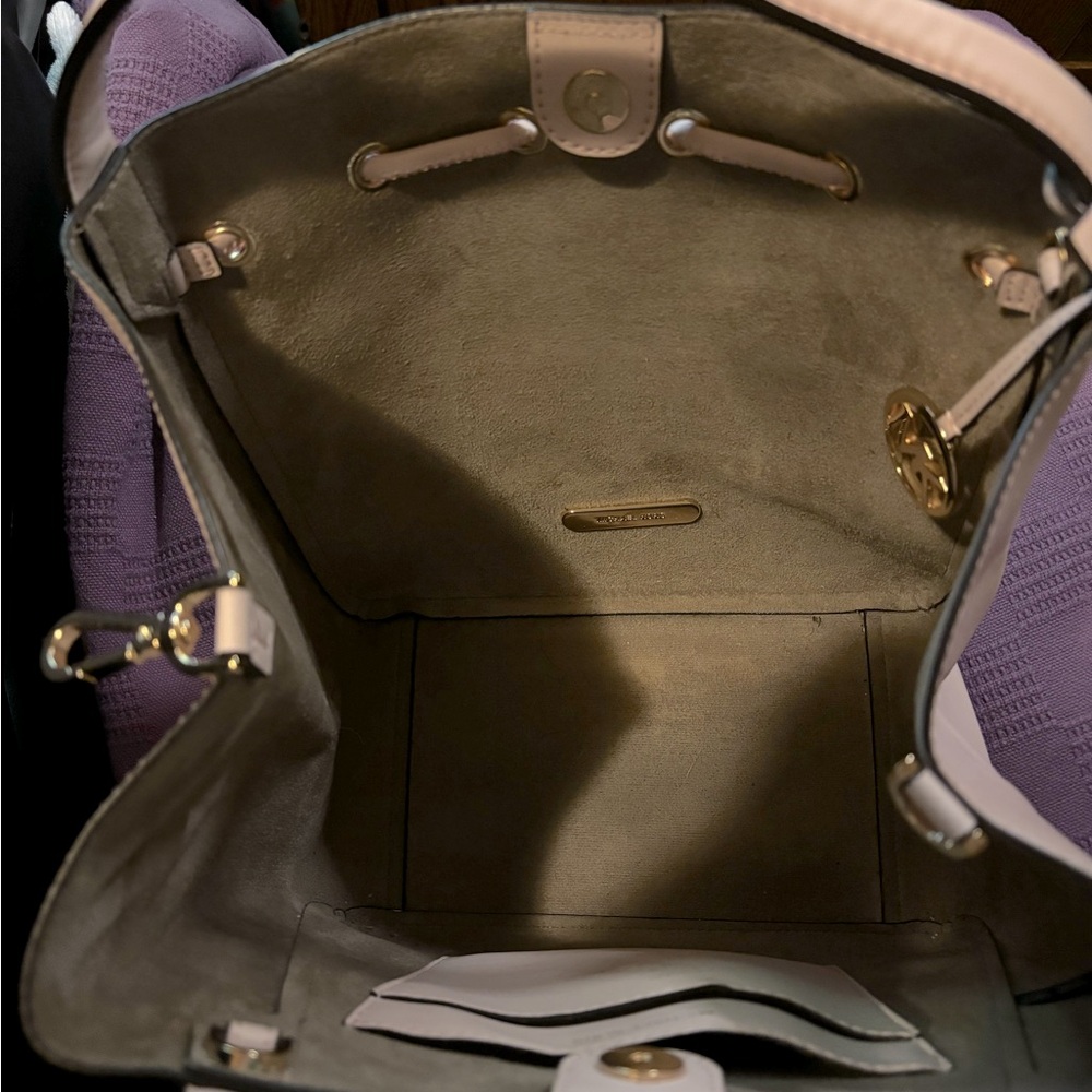 MK Bag, color is a soft pink, cream and the MK LOGO is in a lighter color grey.